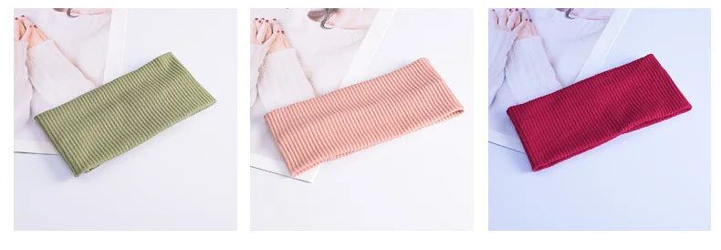 Three knitted headbands in olive green, pink, and red displayed on a white background.