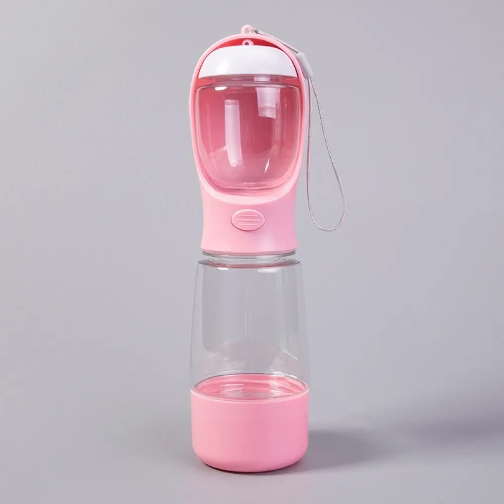 A pink 3-in-1 portable pet water and food dispenser with a clear container and a silicone lid.
