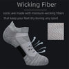 Gray moisture-wicking performance running socks shown on a foot with arrows indicating water drainage.