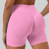 A close-up shot of a woman wearing seamless high-waist yoga leggings in pink.