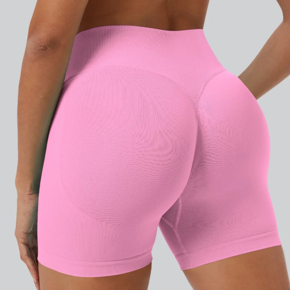 A close-up shot of a woman wearing seamless high-waist yoga leggings in pink.