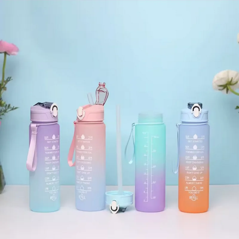 A set of five colorful leakproof sports water bottles with straws arranged on a white surface against a light blue background