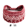 A close-up of a red and white patterned knitted headband for yoga or workout.
