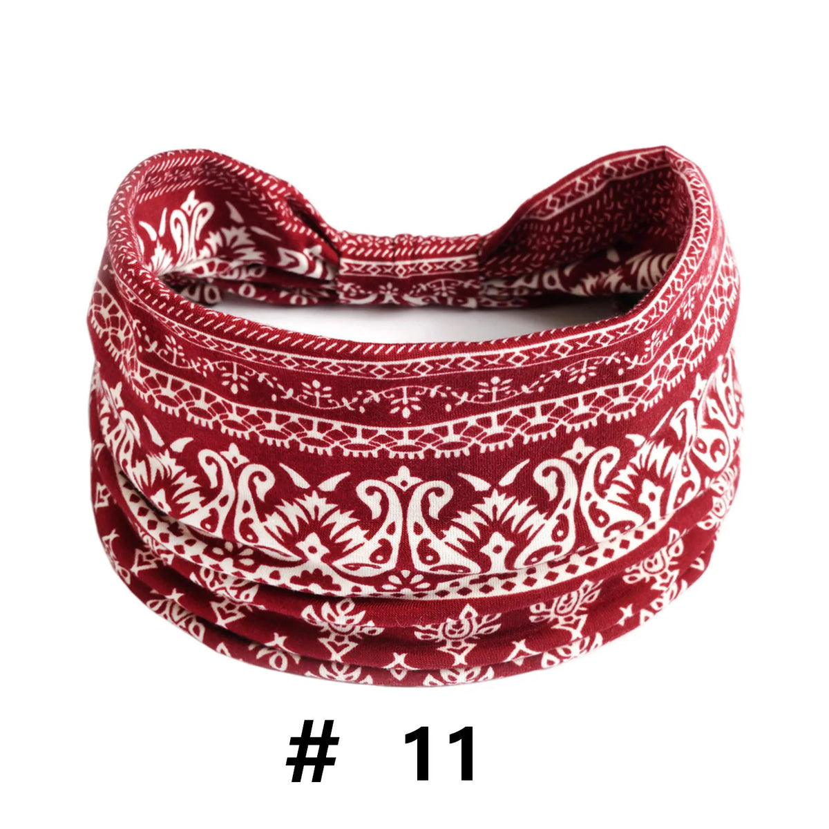 A close-up of a red and white patterned knitted headband for yoga or workout.