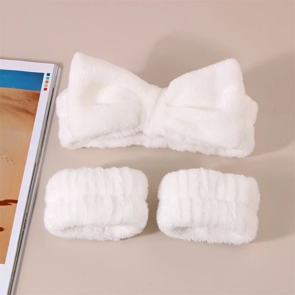 White microfiber spa headband and wristband set displayed on a light background.