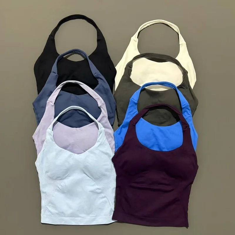 A collection of seamless performance yoga and gym tank tops in various shades of gray, beige, purple, and blue.