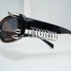 Black sunglasses with spiked rivets and a silver coil detail