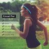 A woman with long hair wearing a blue headband is exercising outdoors.