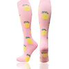 Pair of pink compression socks with yellow lemon designs for circulation and support
