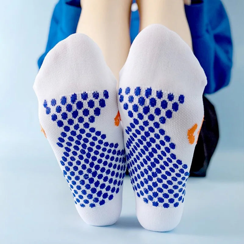Pair of white running socks with blue patterned toe sections and orange accents
