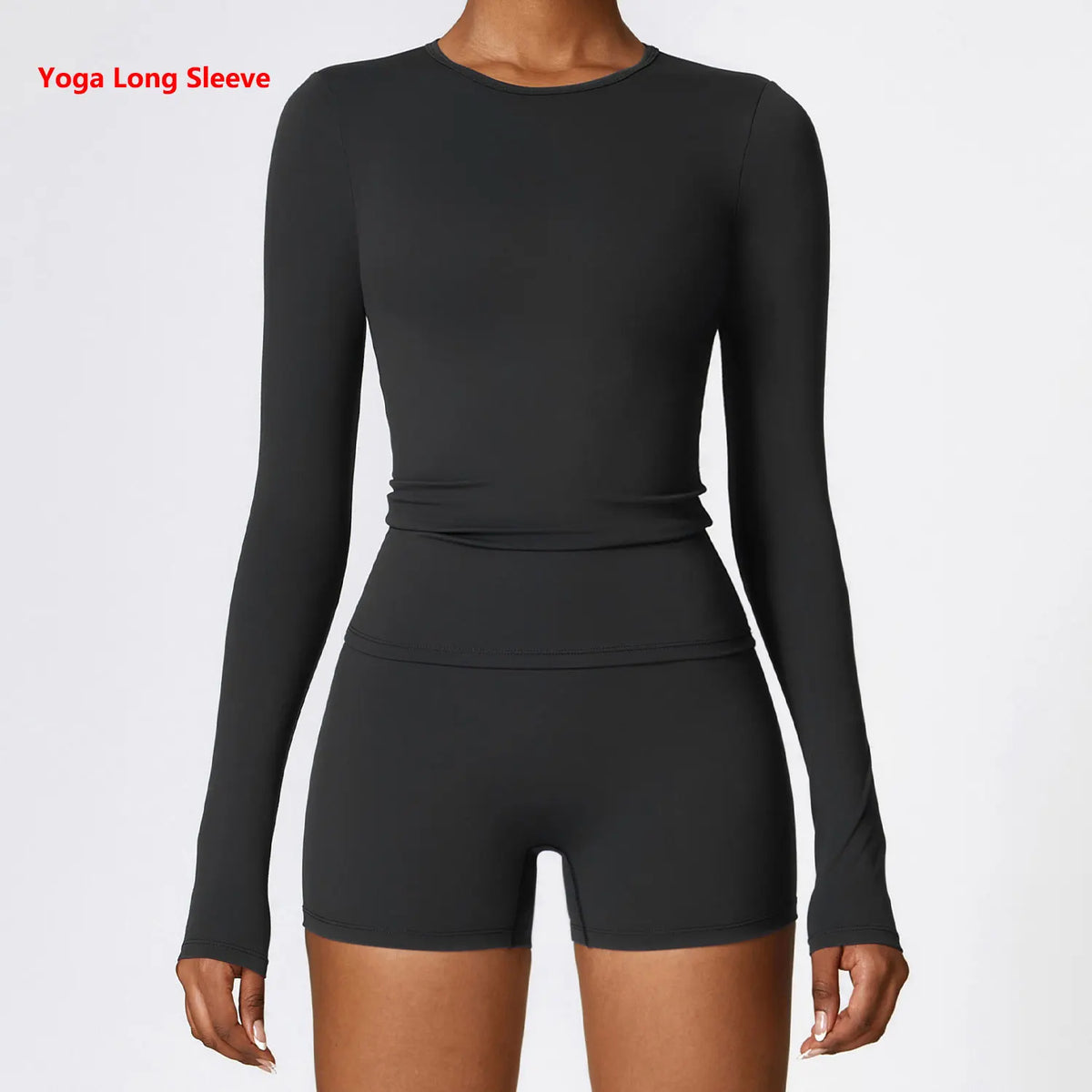 A woman wearing a long sleeve black yoga and fitness t-shirt.