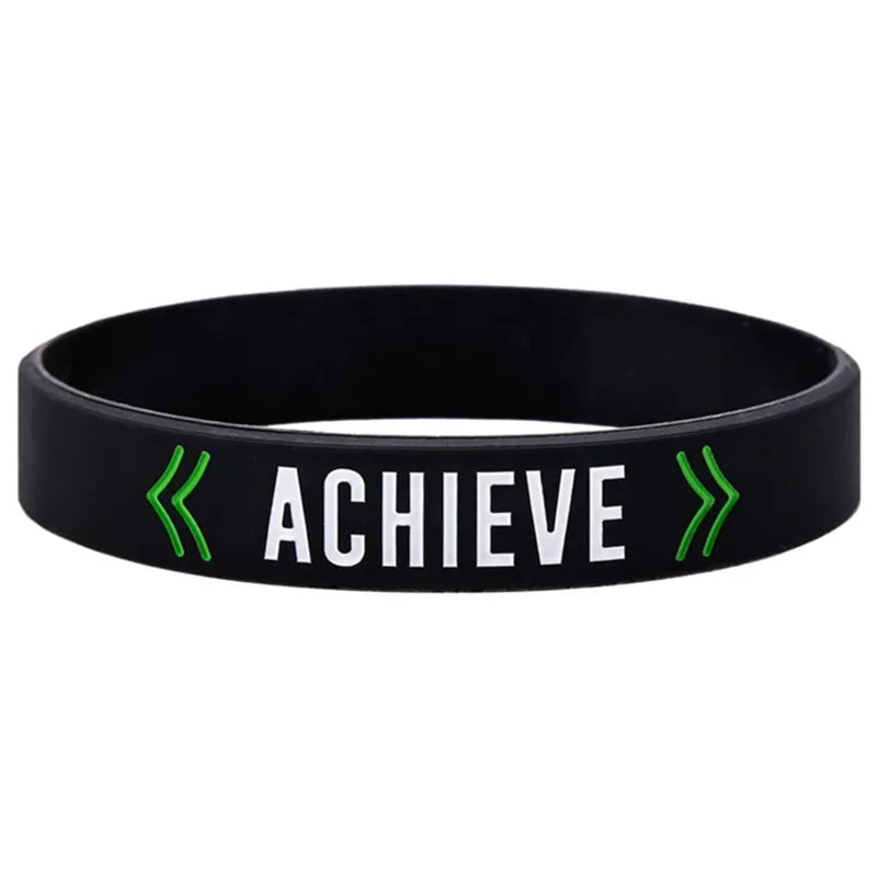 Black silicone wristband with the word ACHIEVE printed in white and green arrows