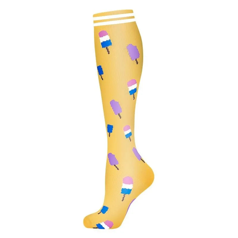 A pair of yellow compression socks with multicolored stripes on the top edge.
