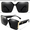 A pair of black square sunglasses shown in front view and laydown, featuring gold accents.