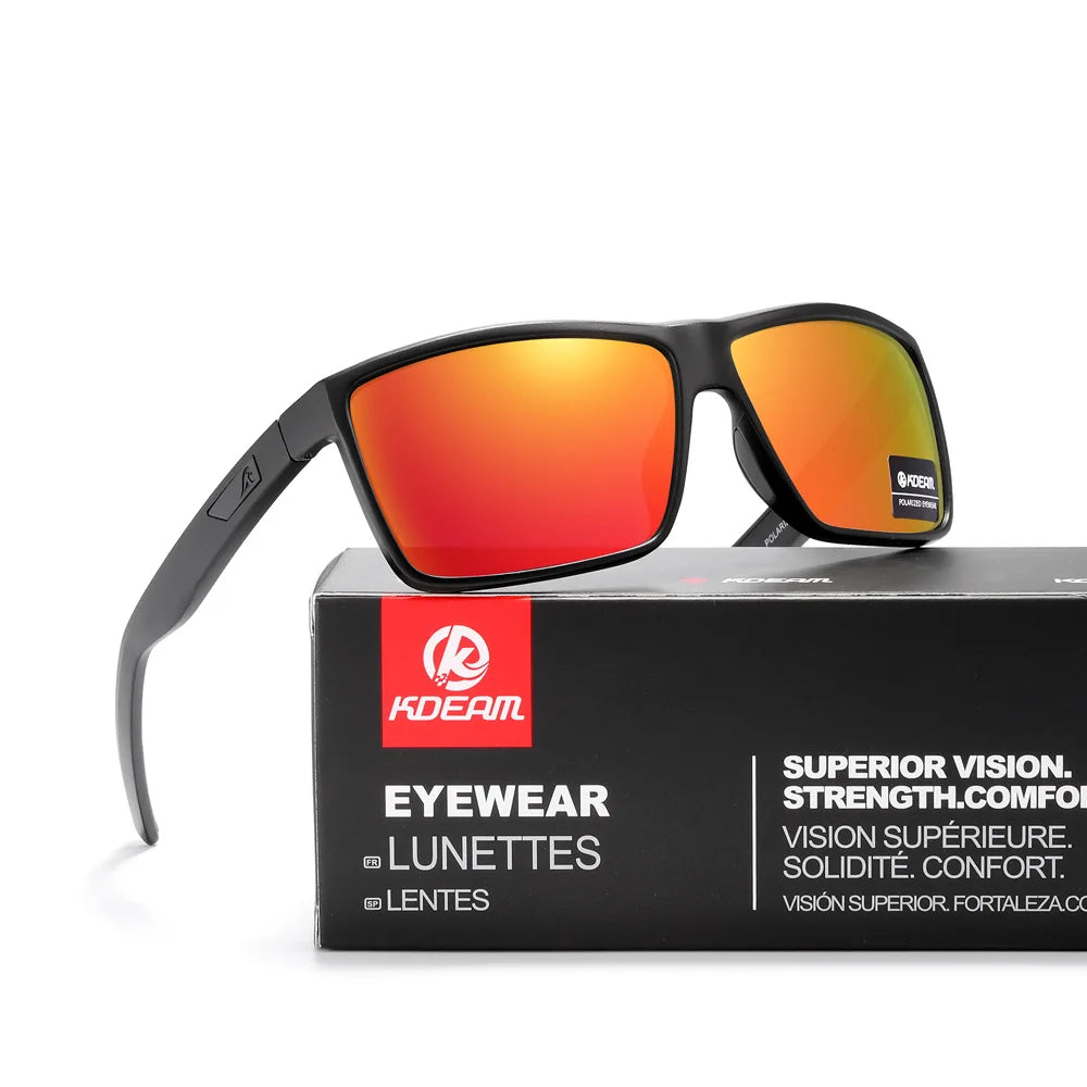 A pair of black-framed sunglasses with orange lenses resting on a box labeled KDEAM Eyewear Lunettes Lentes