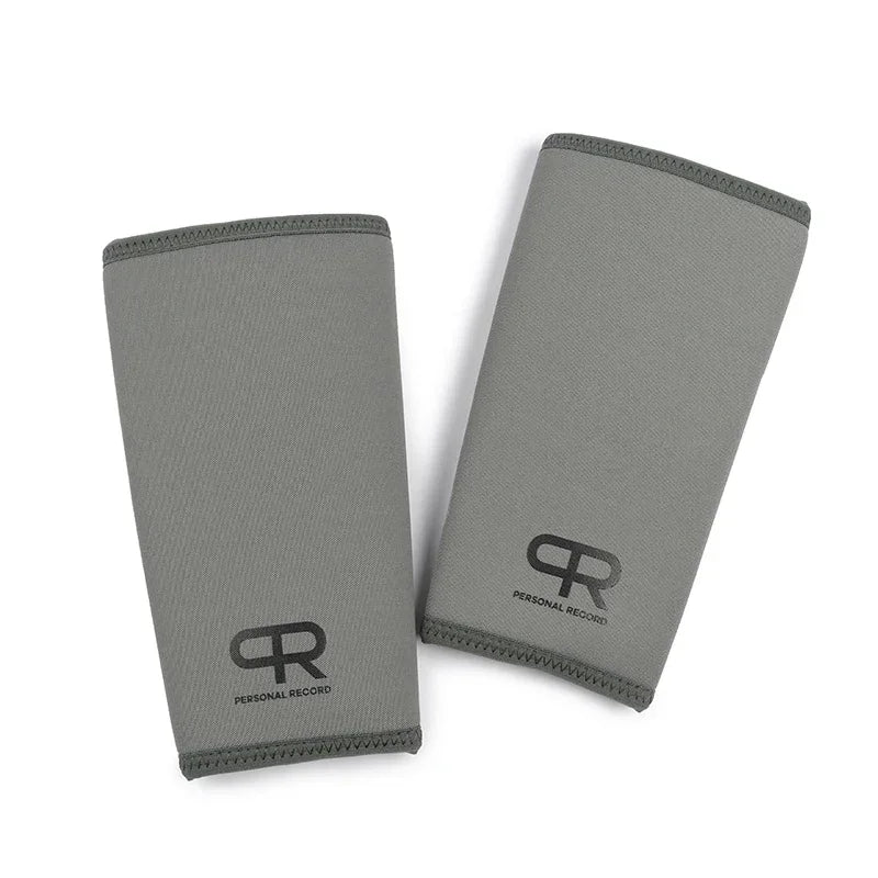 A pair of grey neoprene knee pads for lifting and fitness, shown flat.