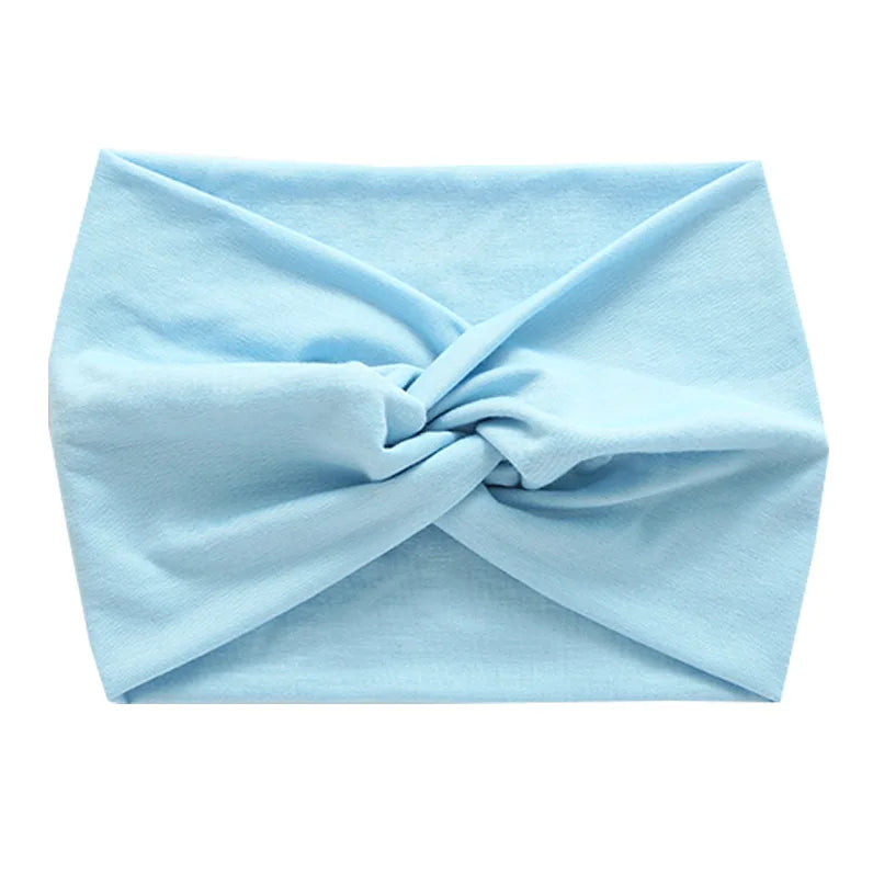 Light blue women's elastic sports headband tied in a knot