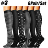 A set of six pairs of black compression socks with white stripes and polka dots.