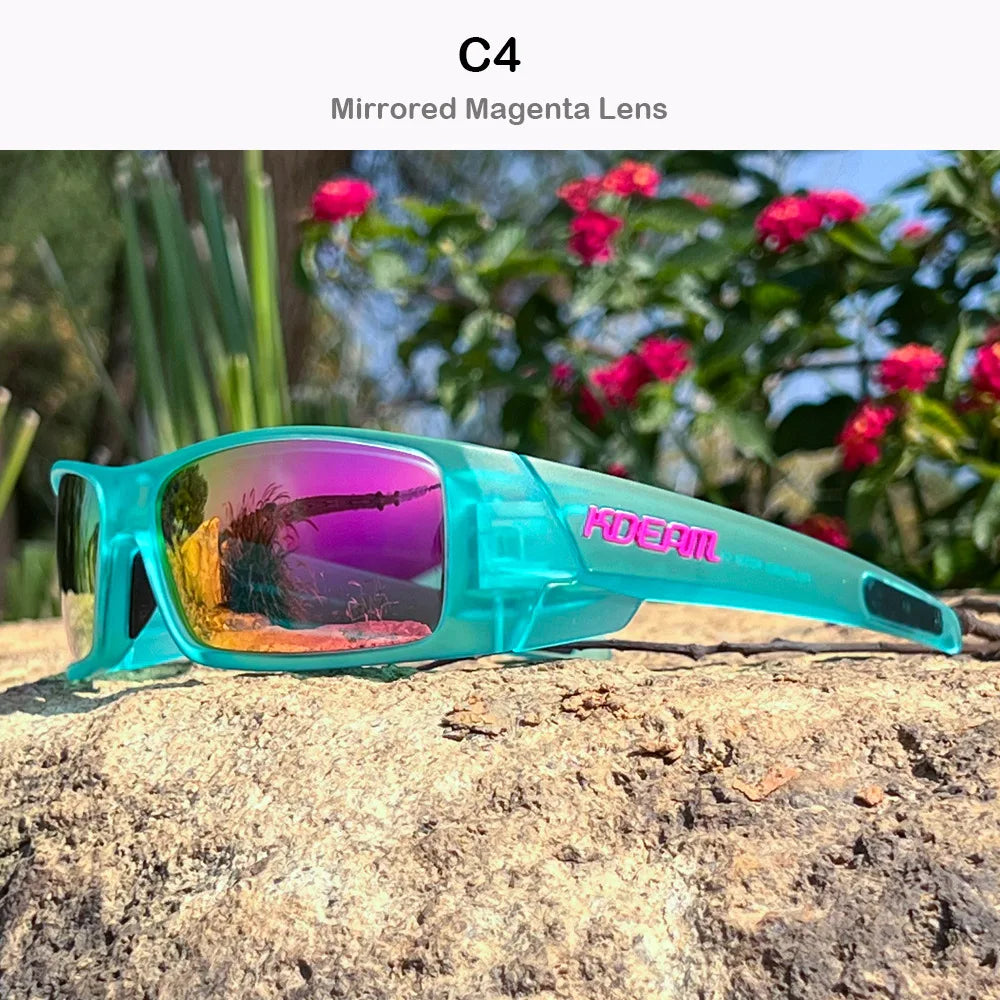A pair of turquoise mirrored magenta polarized sports sunglasses resting on a rough rock outdoors.