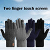 Four pairs of dark knit winter gloves in black, gray, and navy colors displayed against a snowy landscape.