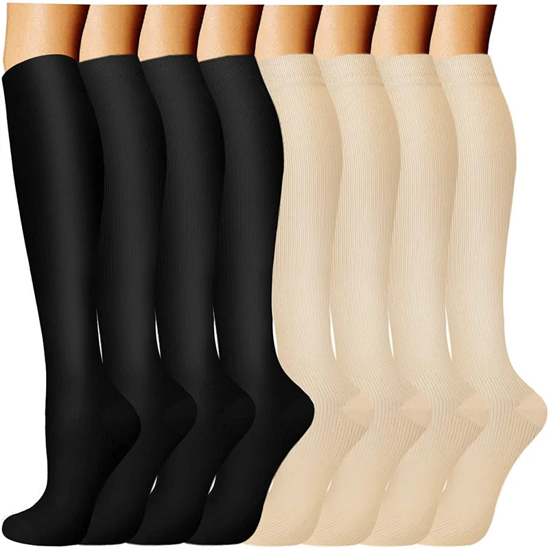 A display of black and beige compression socks for vein support, shown vertically.