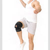A muscular man demonstrates an adjustable knee pad with dual stabilizers for joint support.