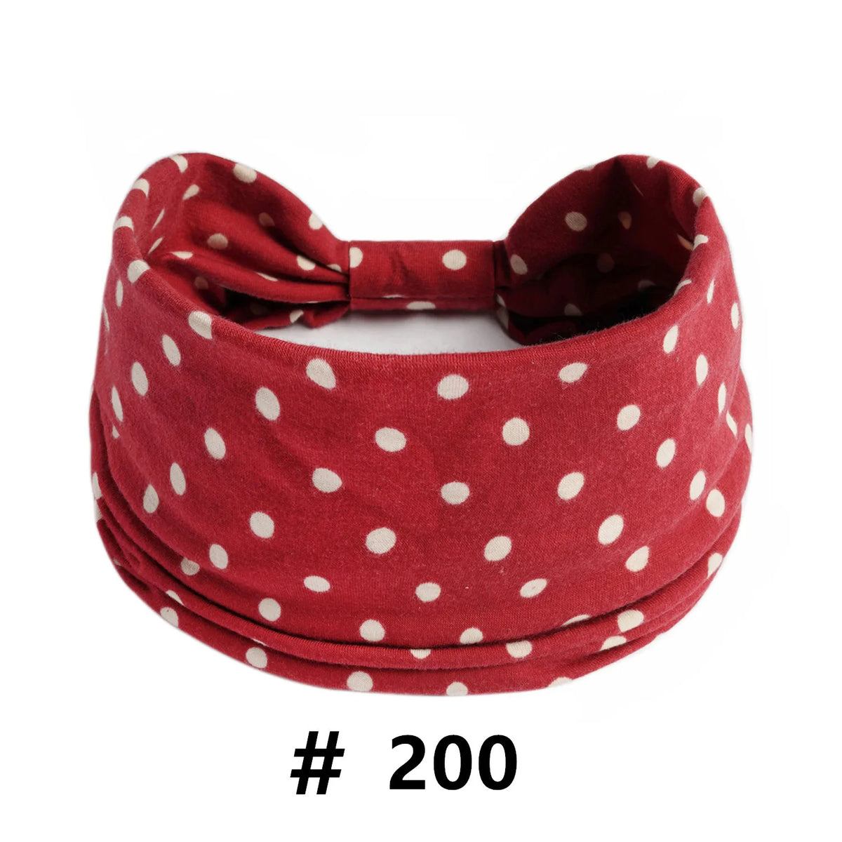 A maroon polka dot knotted headband worn around the head.
