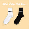 A pair of white striped socks and a pair of black striped socks displayed side by side.