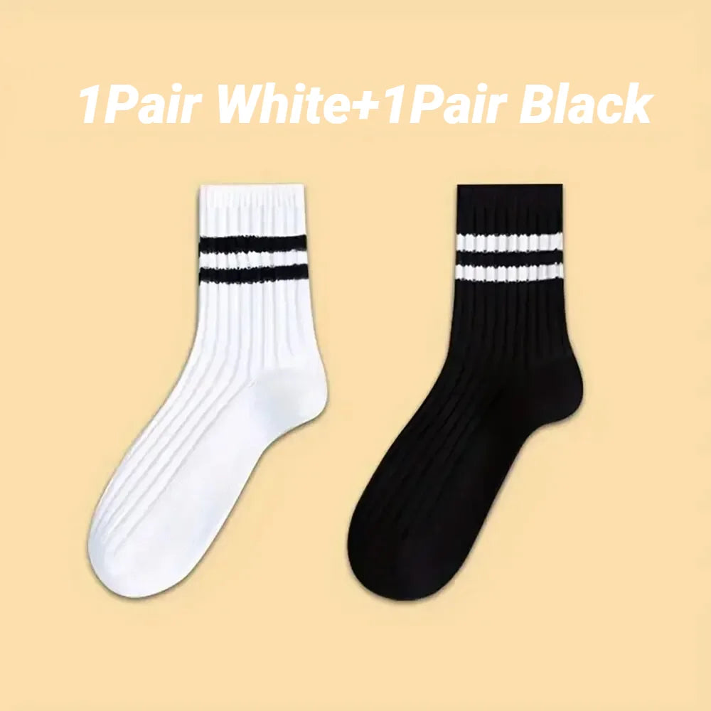 A pair of white striped socks and a pair of black striped socks displayed side by side.