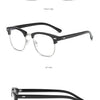 A pair of bright black silver computer glasses shown from the front, side, and angle views.