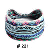 A colorful boho cotton turban headband with geometric patterns in pink, blue, black, and white.
