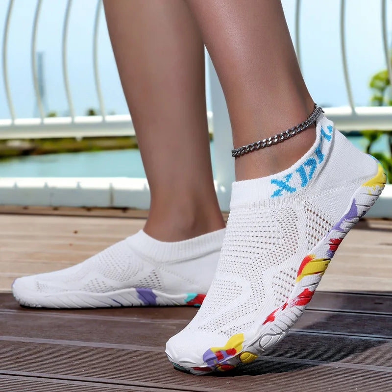 White waterproof quick-dry outdoor hiking shoes worn by a person standing outdoors