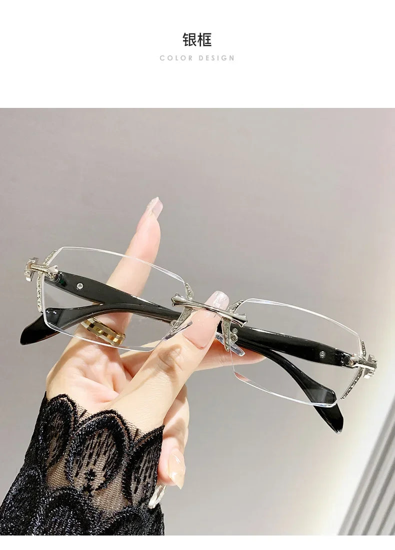 A hand holds a pair of frameless photochromic prescription glasses with blue light blocking features against a light gray bac