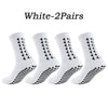 A pair of white multi-sport athletic grip socks shown flat.
