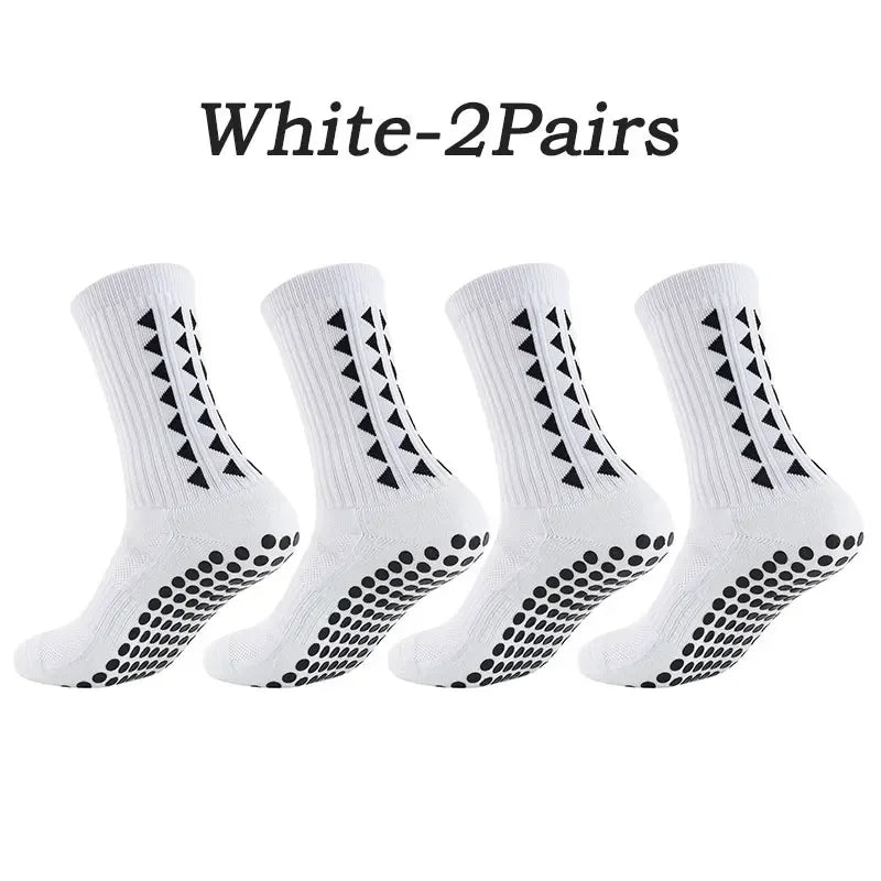 A pair of white multi-sport athletic grip socks shown flat.