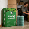A box of rodent repellent balls with a green label and a white mouse silhouette, sitting on a concrete floor.
