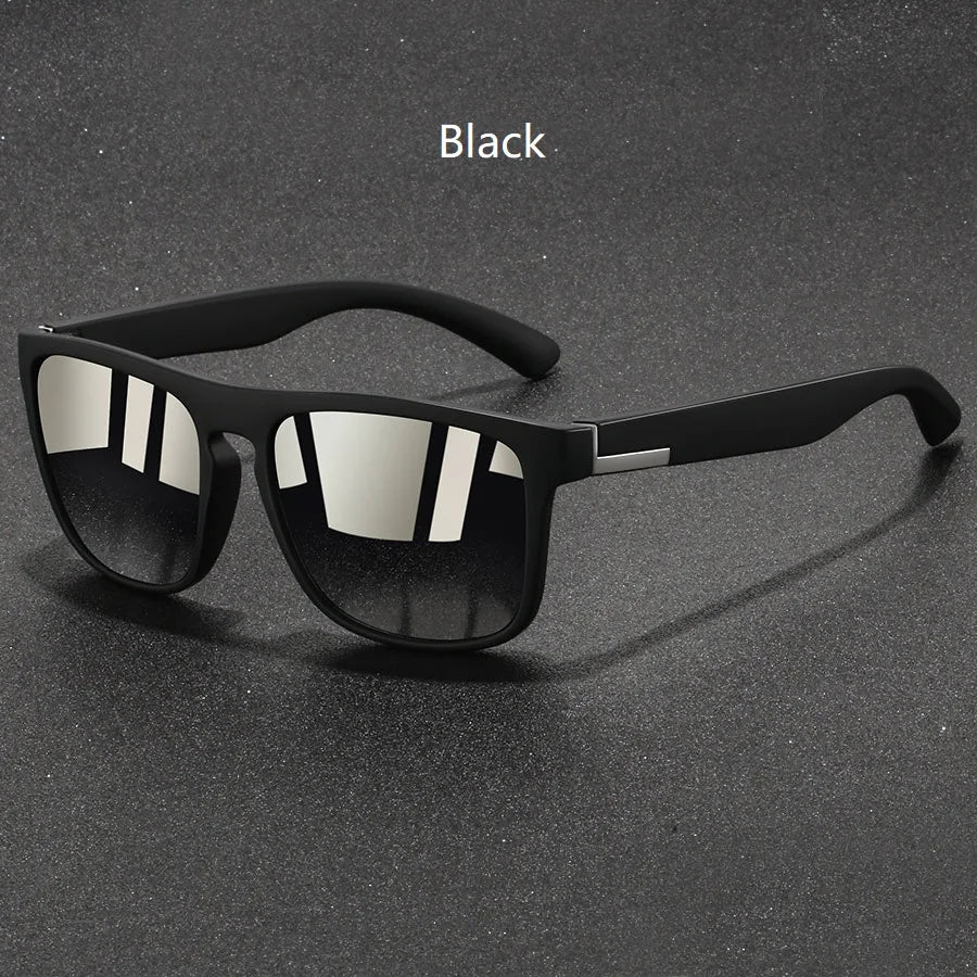 Black vintage designer square sunglasses resting on a dark surface.