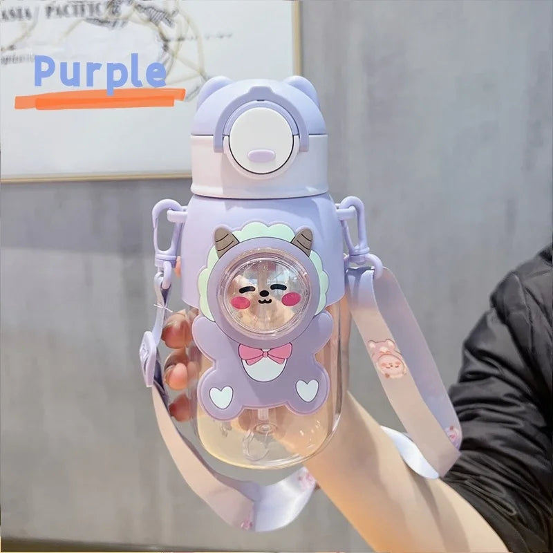 A purple leak-proof water bottle shaped like a cartoon animal is held in a hand.