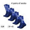 Four pairs of navy blue men's athletic soccer socks with non-slip grip