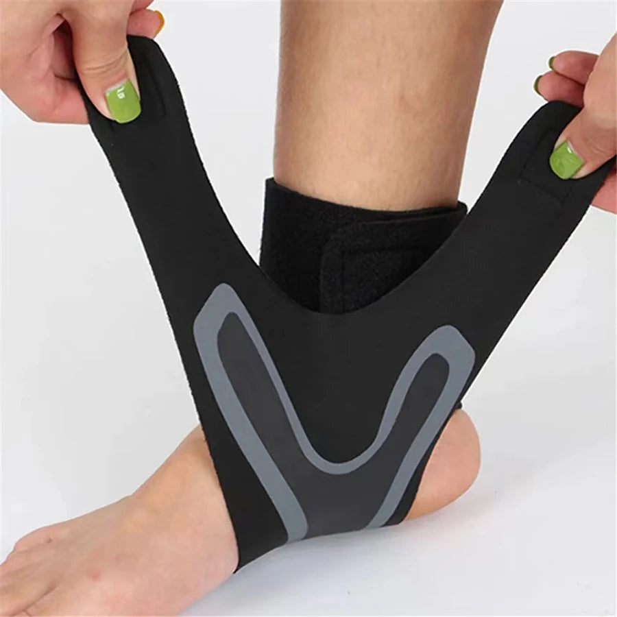 A black ankle support compression sleeve worn on a person's foot and ankle.