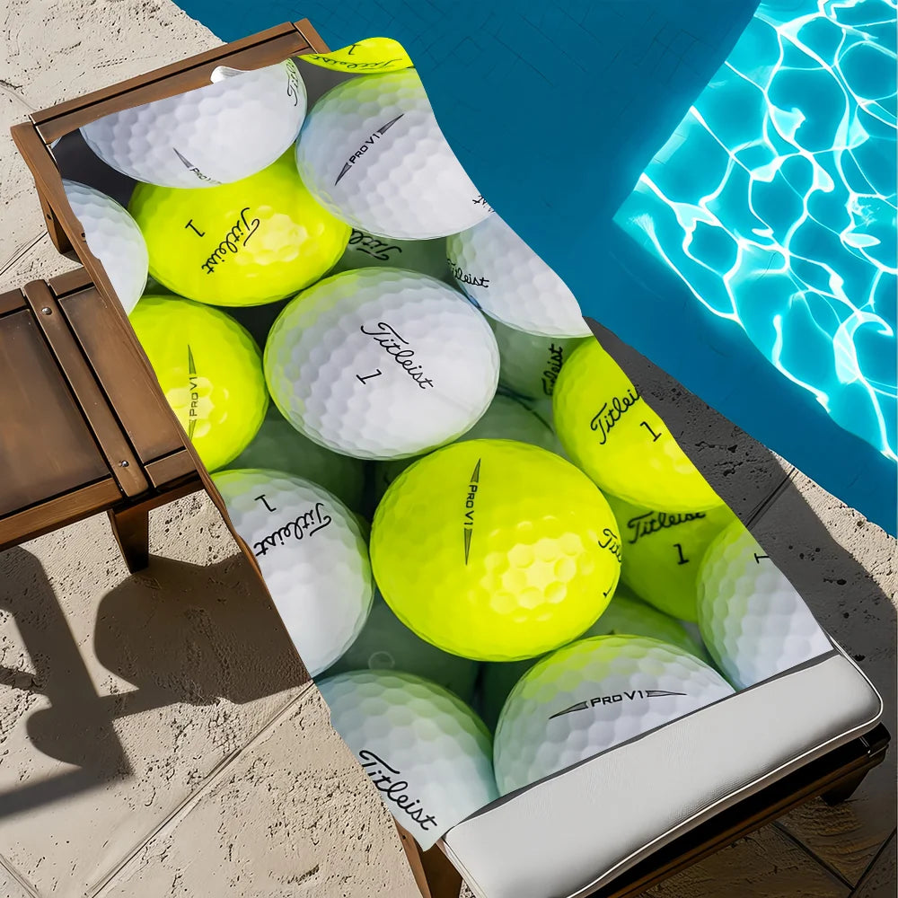 A collection of bright yellow and white golf balls is displayed next to a blue swimming pool.
