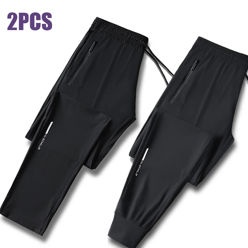 Two pairs of black men's ice silk performance pants shown flat