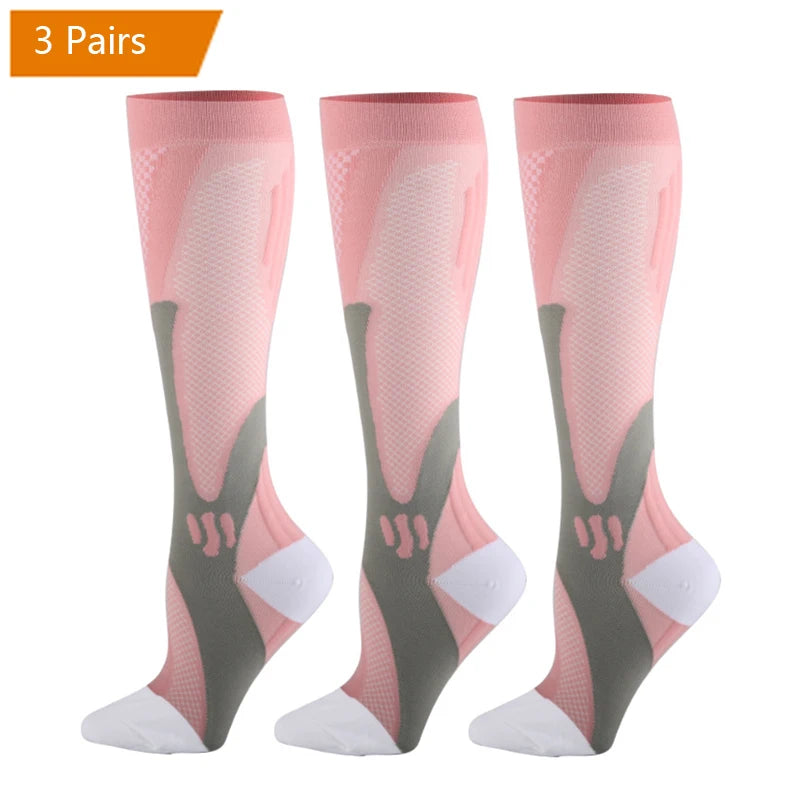 Three pairs of pink compression socks for men in various shades and patterns.