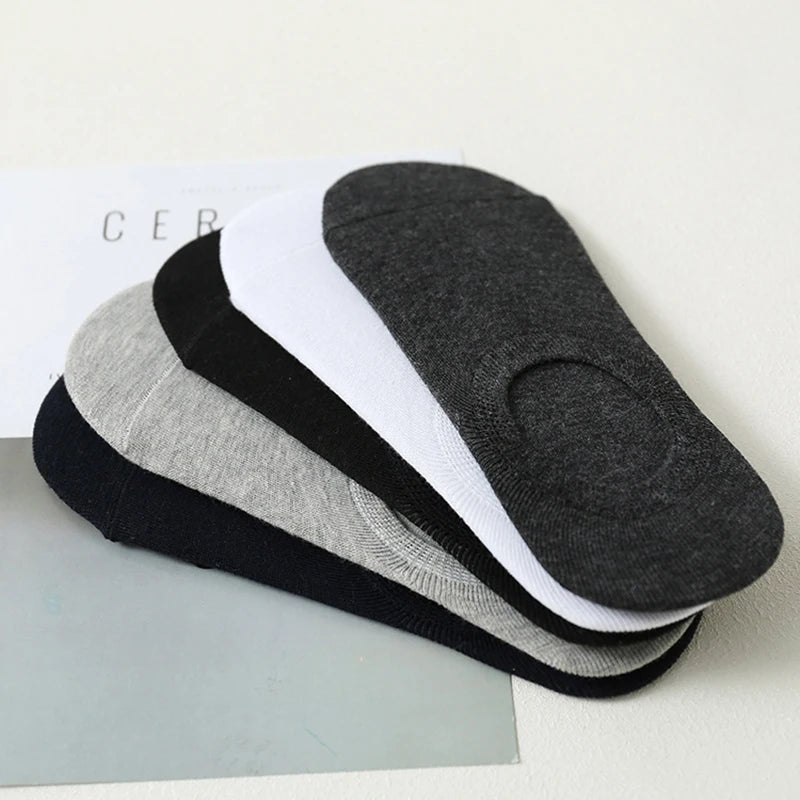 A stack of multi-colored breathable cotton ankle socks in black, gray, white, and black.