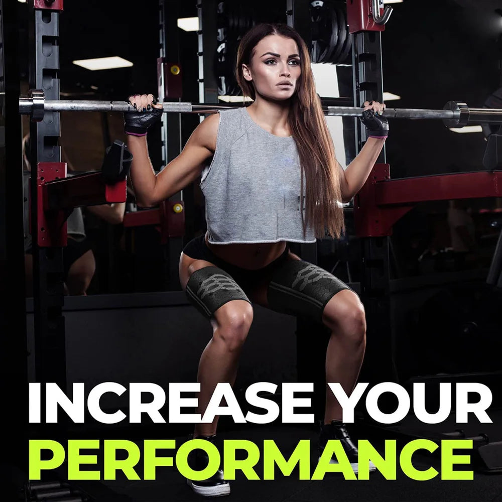 A woman lifting a barbell in a gym setting wearing athletic attire and compression thigh sleeves.