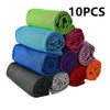 Ten rolled microfiber cooling towels in various colors stacked together.