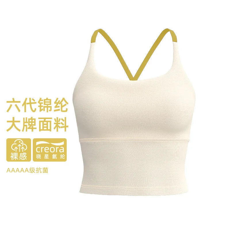 A beige sports bra with thin gold straps shown against a white background.