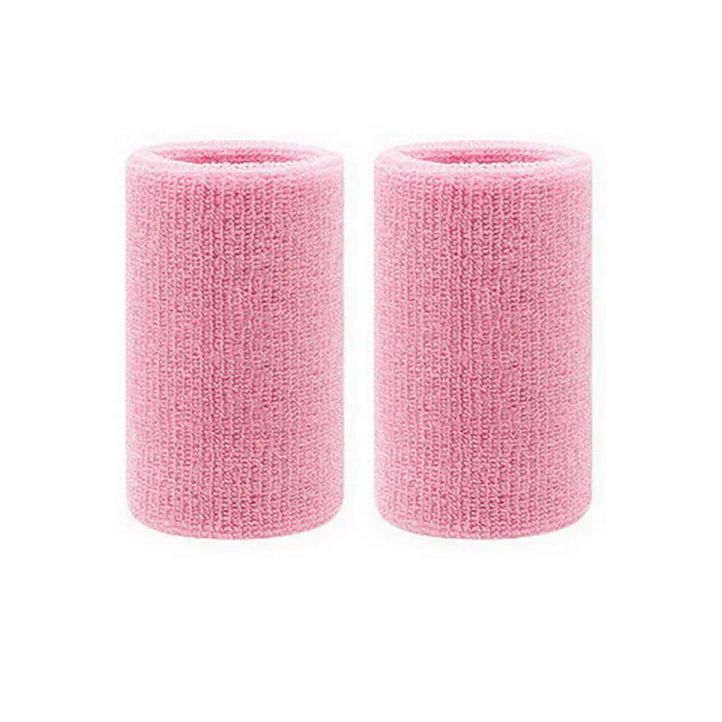 A pair of pink knitted wristbands designed for sweat absorption.