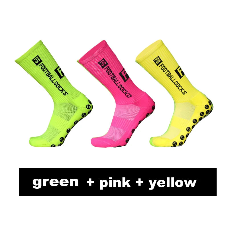 Three pairs of anti-slip silicone grip football socks in green, pink, and yellow.