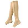 A pair of beige compression stockings with a zipper detail.